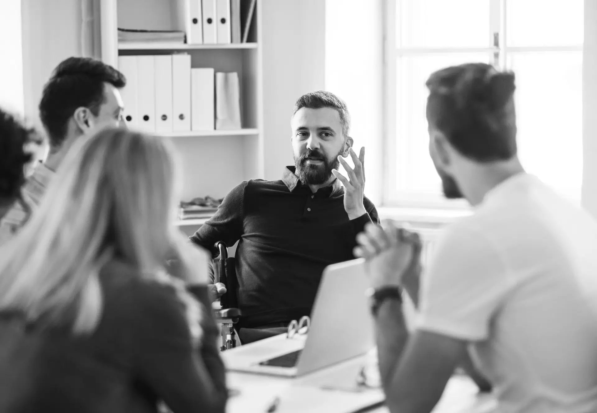 A team engaged in a focused discussion around a table.