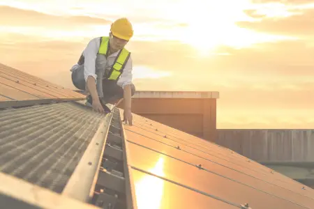 construction workers on roof with sunset in background